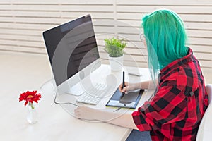 Graphic designer, people concept - Young designer female hipster with graphic tablet working in office, side view