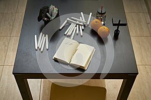 A graphic designer`s desk with routers and a sketchbook and some fruit pieces