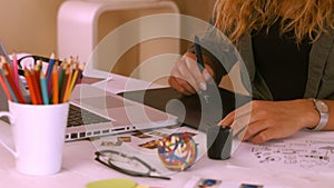 Graphic designer using digitizer at her desk