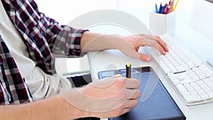 Graphic designer using digitizer at his desk