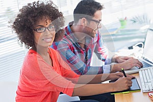 Graphic designer using a graphics tablet in her office