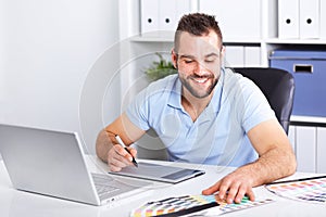 Graphic designer using a graphics tablet in a modern office