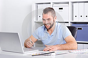 Graphic designer using a graphics tablet in a modern office