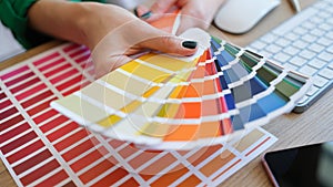 Graphic designer is working on choosing palette colors for creative business