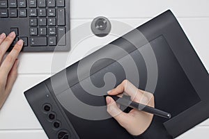 Graphic designer working on digital tablet. The hand draws on a graphics tablet. Freelance, designer, Illustrator. Technology,