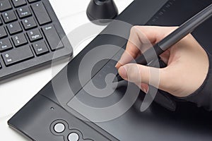 Graphic designer working on digital tablet. The hand draws on a graphics tablet. Freelance, designer, Illustrator. Technology,