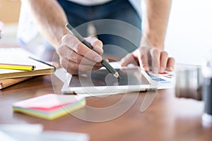 Graphic Designer working with interactive pen display, digital Drawing tablet and Pen on a computer.