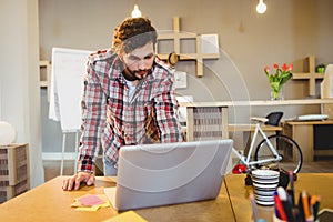 Graphic designer working on laptop