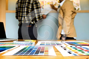 Graphic designers choose colors from the color bands samples for