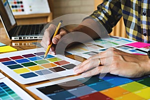 Graphic designers choose colors from the color bands samples for