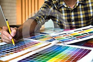 Graphic designers choose colors from the color bands samples for