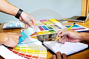 Graphic designers choose colors from the color bands samples for