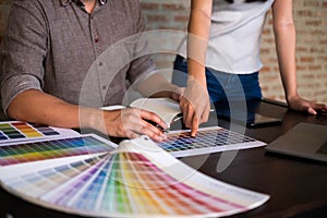 Graphic designers choose colors from the color bands samples for