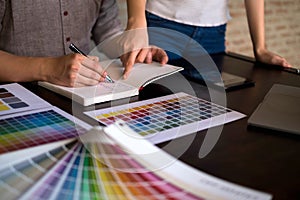 Graphic designers choose colors from the color bands samples for