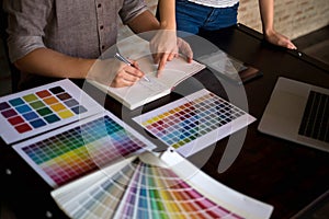 Graphic designers choose colors from the color bands samples for