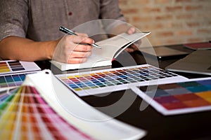 Graphic designers choose colors from the color bands samples for design .Designer graphic creativity work concept