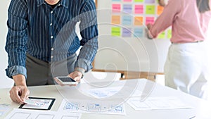 Graphic designers team work together with UX UI designer planning application template layout mobile phone, User experience