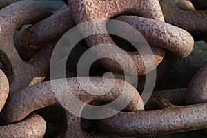 Graphic detail shot of a rusty anchor chain.