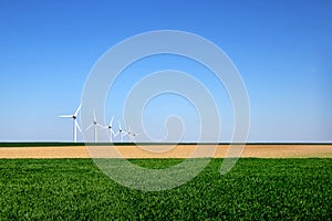 Graphic modern landscape of wind turbines aligned in a field