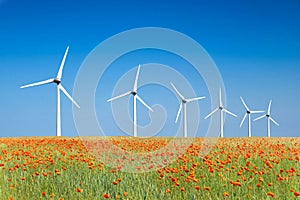 Graphic modern landscape of wind turbines in a poppies field