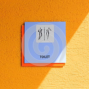 Graphic sign of public toilet with light and shadow