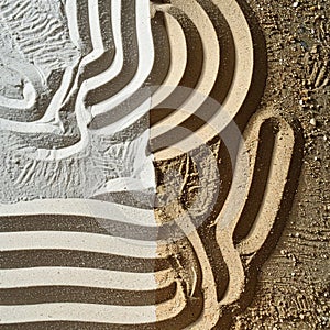 Graphic Striped Hat and Shadow on Textured Sand