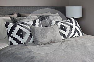 Graphic style and grey shade pillows on classic color bedding