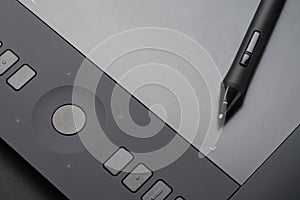 Graphic tablet with pen, close-up photo