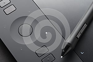 Graphic tablet with pen, close-up photo