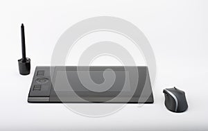 graphic tablet and pen and stand for nibs and mouse on white background