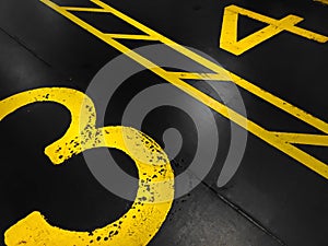Graphic yellow numbers painted on a stark black background photo