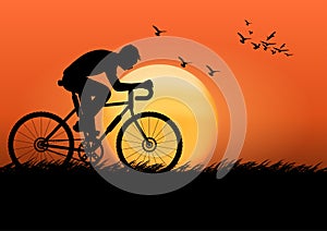 Graphics image man riding a bicycle at evening with a sunset background and orange silhouette of sunset with dark grass on the
