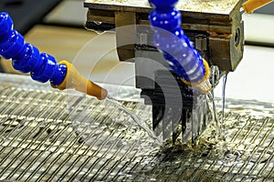 The graphite electrode working on EDM machine with liquid coolant method photo