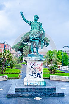 graphitti covered statue of julius caesar in italian city naples....IMAGE