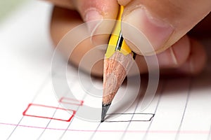 Graphomotor skills. Education concept. The hand writes rectangle. Close up.