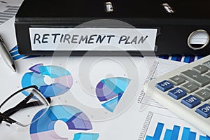 Graphs and file folder with label retirement plan.