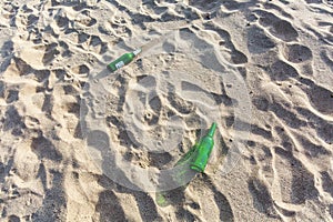 Grass bottle litter in the sand
