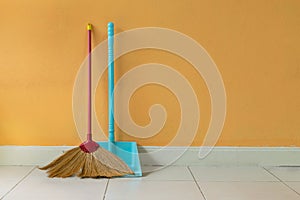 A grass broom and a dust pan