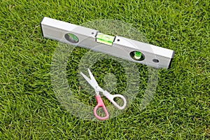 Grass cutting with scissors and using levelling tool to level and cut the grass perfectly