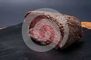 Grass Fed Juicy Corn Roast Beef on black natural stone background