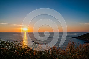 Grass Field in front of the sunset at Leam PromThep Cape in Phuket