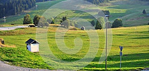 Grass field with a small farmhouse