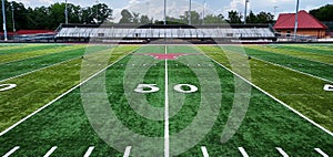 Grass Football Field with Yard Number Fifty with longhorn icon and stands