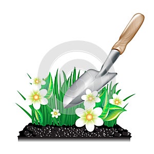 Grass with ground and garden trowel