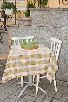 Grass growing from a container located on a restaurant table.