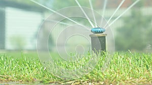 Grass irrigation. Garden Irrigation sprinkler watering lawn.