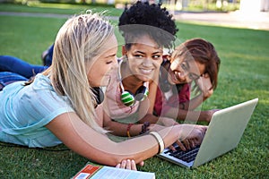 Grass, laptop or students in park at college, campus or together with online course, smile or group. University, relax