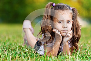 On grass is pretty sad little girl