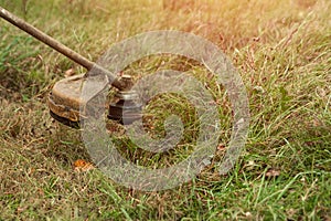 Grass trimmer close up. Mowing lawns, roadsides, mowing grass photo