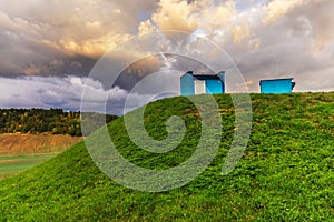 Grassed hill with two objects